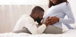man playing with pregnancy
